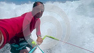 Surfer riding and turning with spray on blue ocean wave, surfing ocean lifestyle, extreme sports, slow motion. Filming