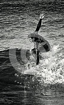 February 2019. Surfer riding a wave alone, sea spray, water sports, cala mesquida beach, mallorca, spain February 2019