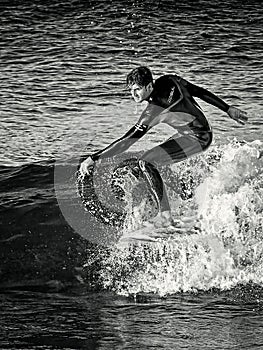 February 2019. Surfer riding a wave alone, sea spray, water sports, cala mesquida beach, mallorca, spain February 2019