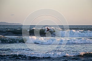 Surfer riding wave at Echo Beach Canggu Bali Indonesia