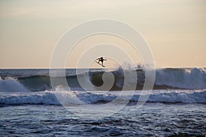 Surfer riding wave at Echo Beach Canggu Bali Indonesia