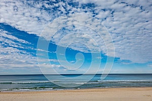 Surfer`s Paradise beach to sea and horizon with white soft clouds formation photo