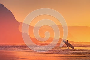 Surfer silhouette at sunset