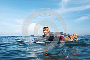 Surfer. Smiling Surfing Man On Surfboard Portrait. Handsome Guy In Wetsuit Swimming In Ocean.