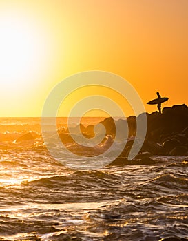 Surfer Standing on the Point with Surfboard