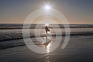 Surfer at sunset on Pacific Beach