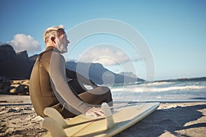 Surfer, surfboard and senior man on beach for surfing adventure trip waiting for sea waves in nature for water sports