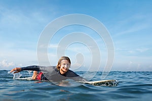 Surfer. Surfing Man On Surfboard Portrait. Smiling Guy In Wetsuit Swimming In Ocean.
