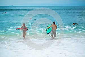 Surfer. Surfing Man With Surfboard Walking On Sandy tropical Beach. Healthy Lifestyle, water activities, Water Sport. Beautiful