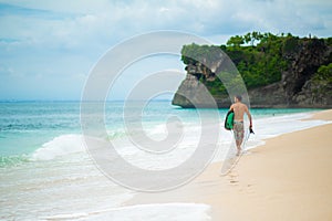 Surfer. Surfing Man With Surfboard Walking On Sandy tropical Beach. Healthy Lifestyle, water activities, Water Sport. Beautiful