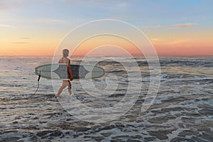 Surfer. Surfing Man With White Surfboard Walking In Ocean. Water Sport For Active Lifestyle.