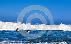 Surfer surfing on surfboard on high waves in Puerto Escondido Mexico