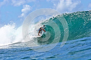 Surfer Surfing the Tube of a Wave in Hawaii