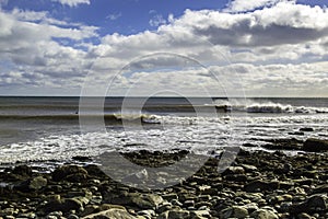 Surfer surfs a perfect wave on a sunny day