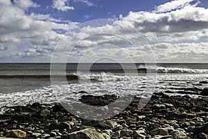 Surfer surfs a perfect wave on a sunny day