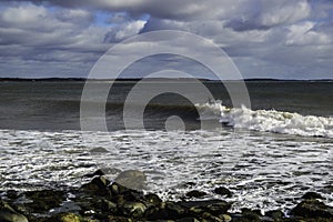 Surfer surfs a perfect wave on a sunny day