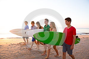 Surfer teen boys girls group walking on beach