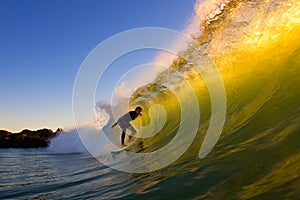 Surfer In The Tube at Sunset