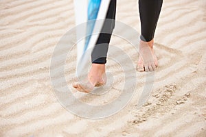 Surfer, walking or feet on beach sand with surfboard on vacation for fitness training, wellness or travel. Legs of