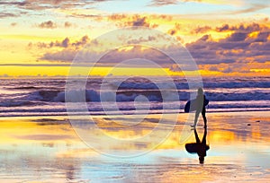 surfer walking sunset Bali beach