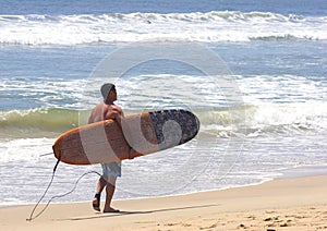 Surfer walking with surfboard