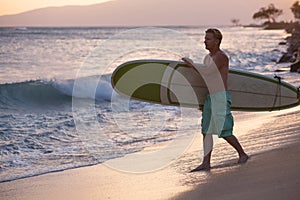 Surfer Walking Surfboard to Water