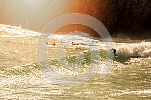 Surfer on the wave at sunset