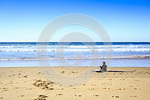 Surfer on wild beach in western Portugal