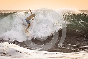 Surfer on wild Ocean Wave in Bali