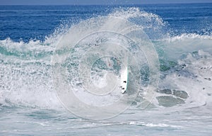 Surfer wipesout while surfing in Laguna Beach, California.