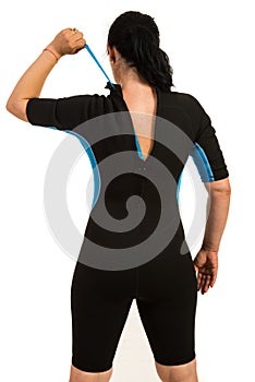 Surfer woman closing zipper to wetsuit