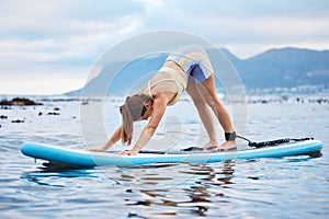 Surfer woman, surfboard and stretching on water, beach or yoga practice for peace, wellness or calm. Female, surf and