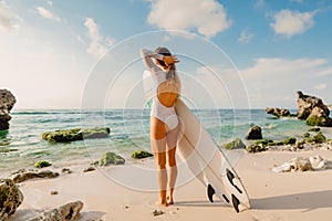 Surfer woman with surfboard. Surfing in ocean