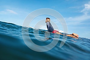 Surfer. Young Man On Surfboard Portrait. Cool Guy In Wetsuit Swimming In Ocean.