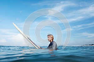 Surfer. Young Man In Wetsuit On White Surfboard Portrait. Handsome Guy In Ocean.