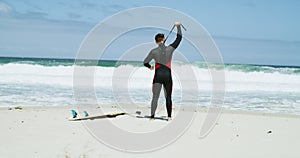 Surfer, zipping wetsuit and beach for surfing, tourist for adventure, holiday hobby and environment. Explorer, vacation