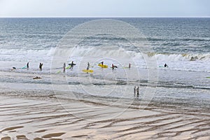 Surfers on the Atlantic ocean beach in Lacanau-Ocean, Bordeaux, France