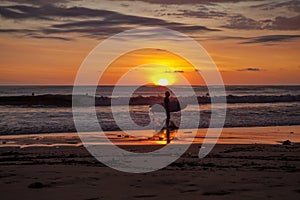 Surfers on the beach of Santa Teresa at sunset / Costa Rica