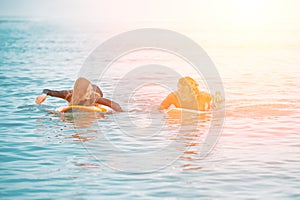 Surfers at the beach- Smiling couple of surfers walking on the beach and having fun in summer. Extreme sport and