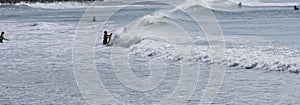 Surfers and bodyboarders enjoying the waves at Portrush Beach North Coast Antrim Northern Ireland