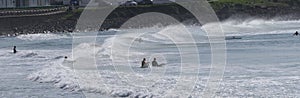 Surfers and bodyboarders enjoying the waves at Portrush Beach North Coast Antrim Northern Ireland