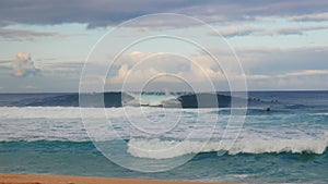 Surfers catch waves at pipeline on the north shore of oahu