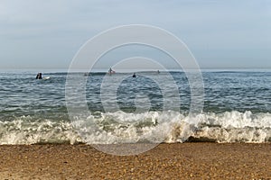 Surfers challenging the waves