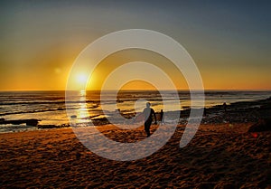 Surfers Coming in at Sunset