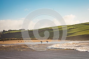 Surfers leaving the water on Winters day.