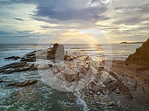 Surfers in magnific rock bay photo