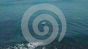 Surfers in the ocean, male surfer catches and ride a massive barreling waves.