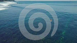 Surfers in the ocean, male surfer catches and ride a massive barreling waves.