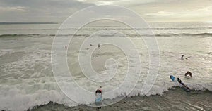 Surfers ride the waves, Bali Indonesia