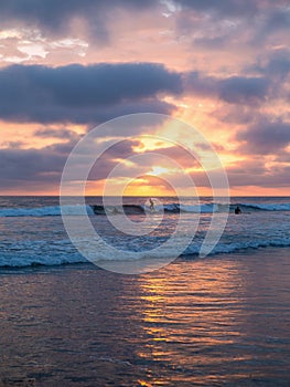 Surfers at sunset